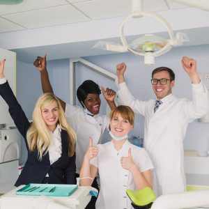 Group of dental professionals celebrating in office