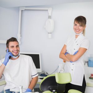 Male and female dentists smiling