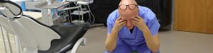 Older Dentist stressing in operatory