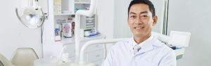 Asian Dentist in dental office