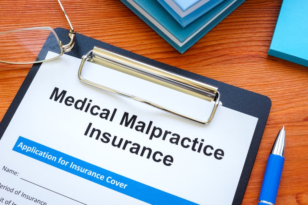 An image of a medical malpractice insurance application form on a clipboard.