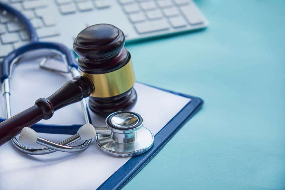 Gavel and stethoscope representing medical jurisprudence, legal definition of medical malpractice, attorney roles, and common errors by doctors, nurses, and hospitals.