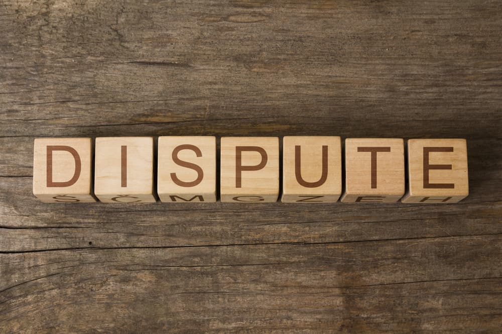 Word Dispute written on wooden blocks