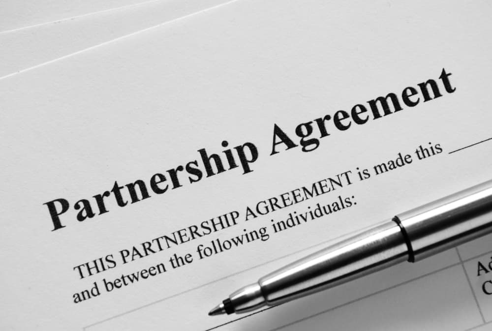 Close up Partnership Agreement Paper and Pen, Emphasizing the Title Part.