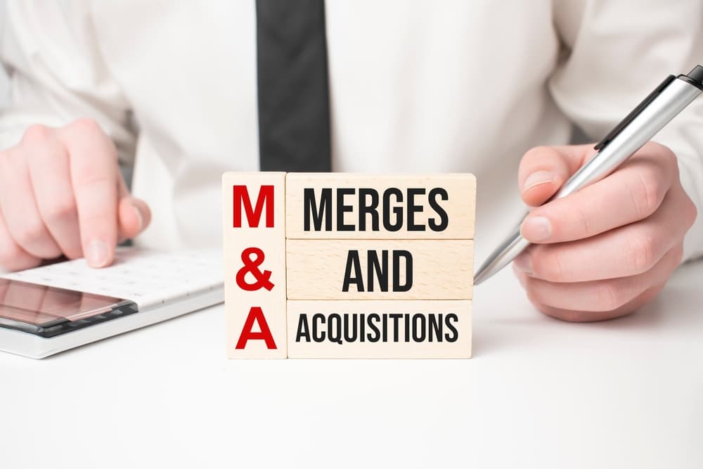 M&A: Mergers & Acquisitions written on wooden blocks