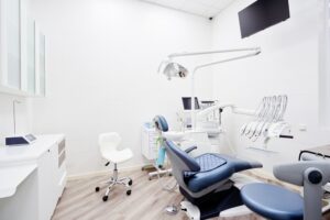 Dental practice treatment room showing chair and specialized equipment.