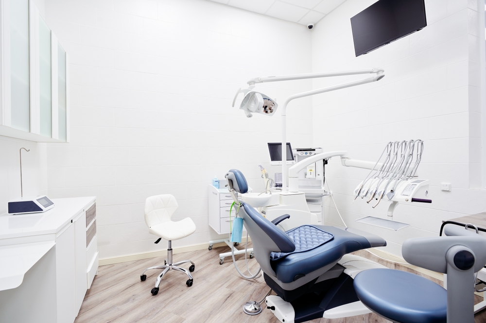 Dental practice treatment room showing chair and specialized equipment.