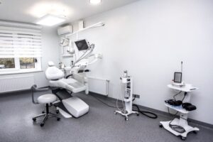Modern dental treatment room with exam chair and equipment, representing a typical office setup for real estate ownership considerations